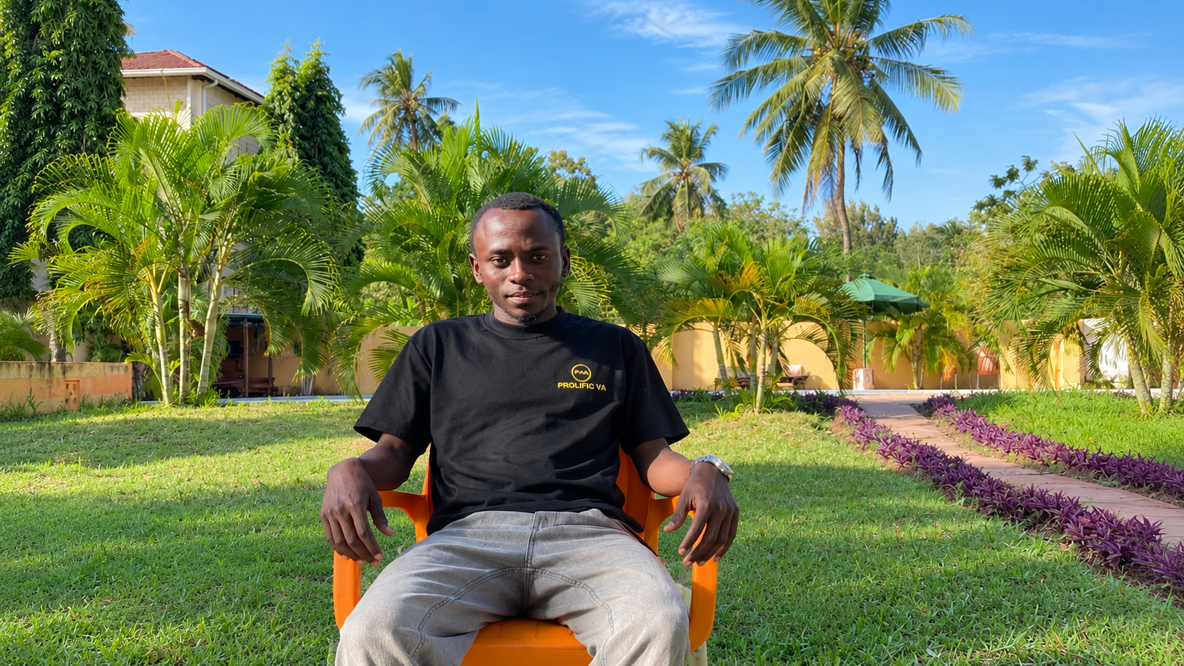 Mohammad Nyundo of Prolific VA posing for a potrait infront of a tropical garden